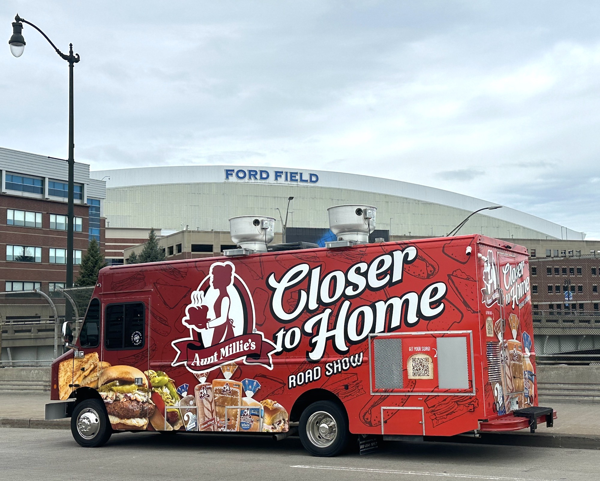 Aunt Millie's Closer to Home road show truck in front of Ford Field